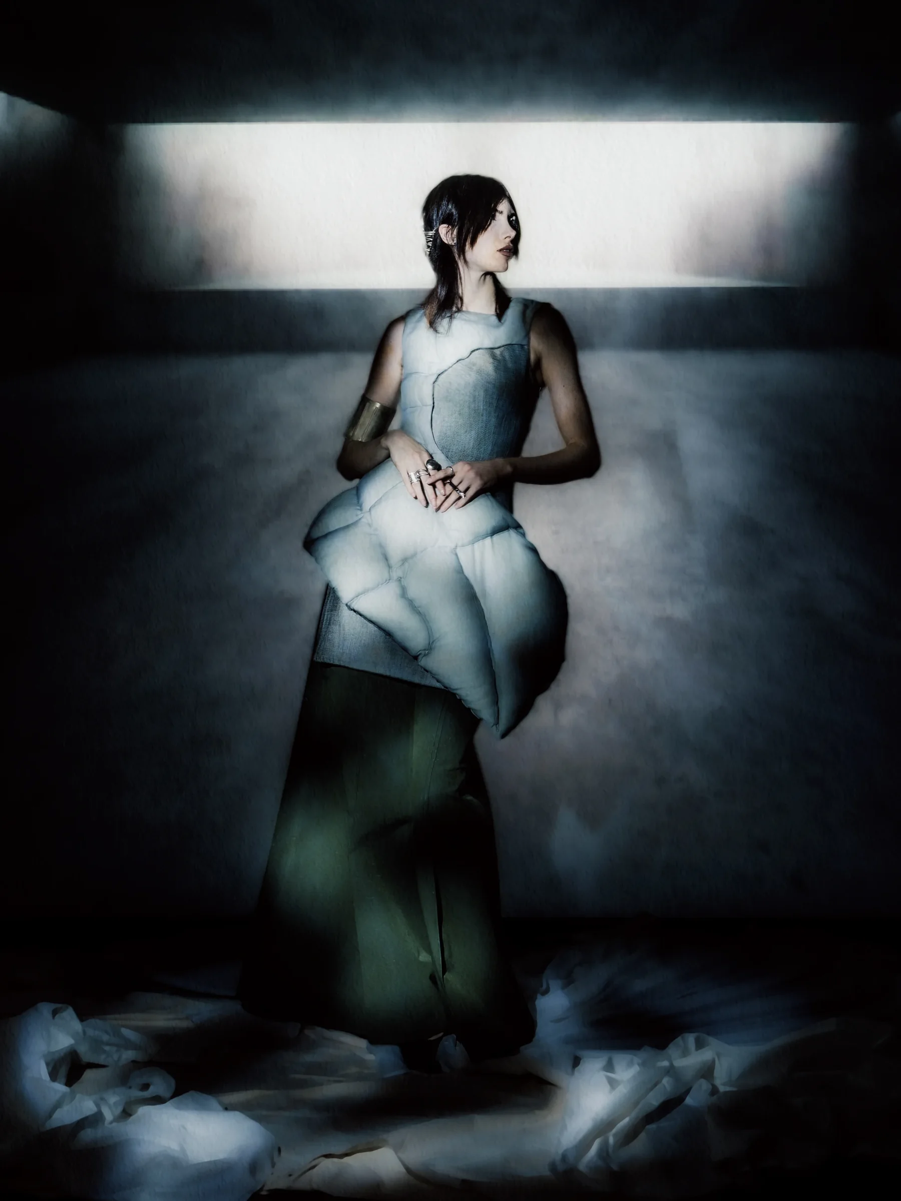 Model wearing a sculptural blue garment in Constructed Stillness